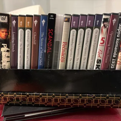 Collection of educational and entertainment DVDs, including sets from The Great Courses, television series, and foreign films, organized...