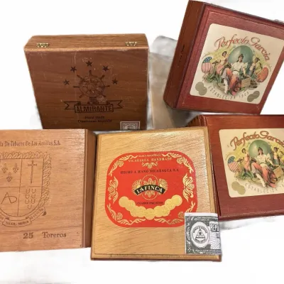 Collection of five vintage wooden cigar boxes, including brands like Perfecto Garcia, Almirante, and La Finca.