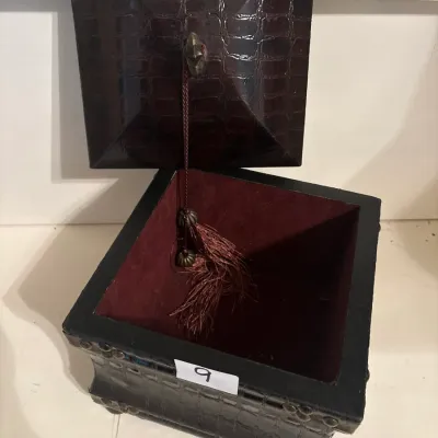 Faux alligator embossed leather keepsake box featuring a burgundy felt-lined interior, tassel accent, and brass stud trim.