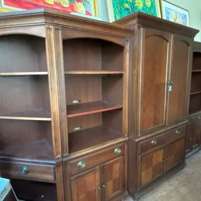 Large multi-piece traditional wood entertainment wall unit featuring open display shelving, a central cabinet armoire, corner shelving,...