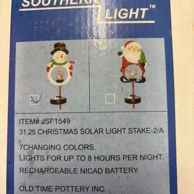 Original packaging box for a Southern Light 31.25-inch Christmas solar light stake by Old Time Pottery, featuring a snowman design.