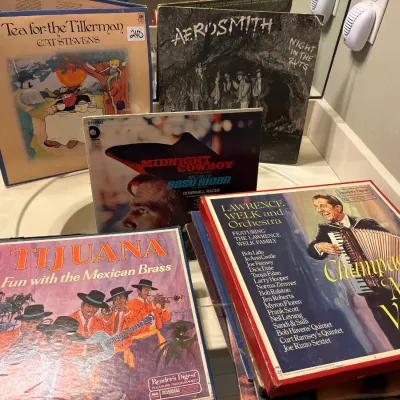 Collection of vintage vinyl LP records and box sets, featuring albums by Cat Stevens, Aerosmith, Tijuana, and Lawrence Welk.