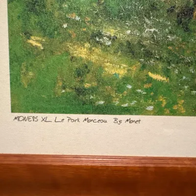 Framed reproduction print of Monet's "Le Parc Monceau", featuring handwritten title inscription along the lower margin.
