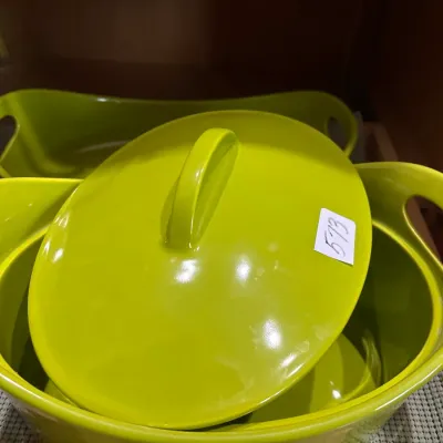 Lime green ceramic covered casserole dish featuring side cutout handles and matching lid.