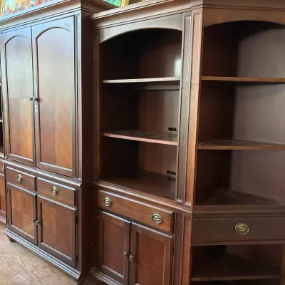 Large multi-piece mahogany entertainment wall unit featuring armoire doors, open shelving, and lower cabinet storage.