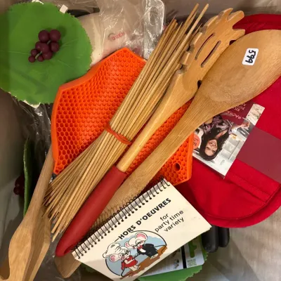Box lot of kitchen accessories and utensils, including wooden servers, a bamboo whisk, silicone trivets, pot holders, and a vintage hors...