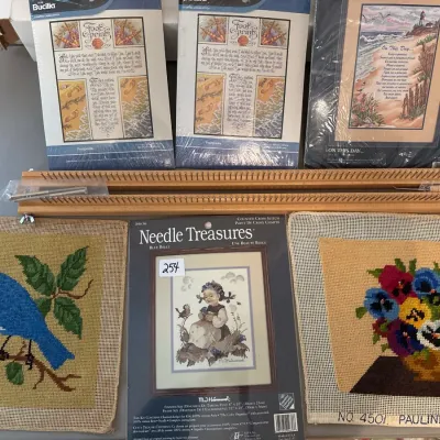 Collection of cross-stitch and needlepoint supplies, including packaged kits by Bucilla and Needle Treasures, completed/in-progress...