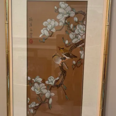 Framed Asian silk embroidery featuring birds perched among white magnolia blossoms, set in a gilded faux bamboo frame.