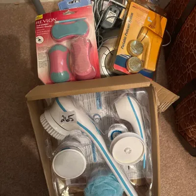Collection of personal care and bath products, including a spin spa body brush kit in box, Revlon Pedi-Expert kit, and Walgreens portable...