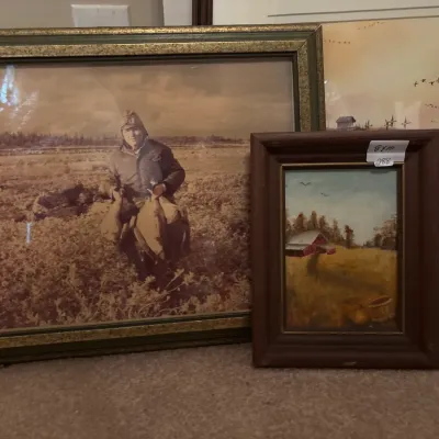 Collection of vintage framed art, including a large sepia-toned photograph of a hunter with game and a small oil painting of a rural barn...