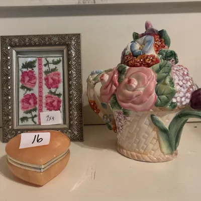 Floral ceramic teapot in a basket-weave design paired with a small heart-shaped alabaster trinket box and a framed miniature needlepoint...
