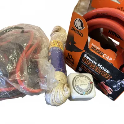 Assortment of utility supplies, including an orange Rhino Sewer Hose Rinser Kit, a bundle of white rope, an Intermatic plug-in timer, and...