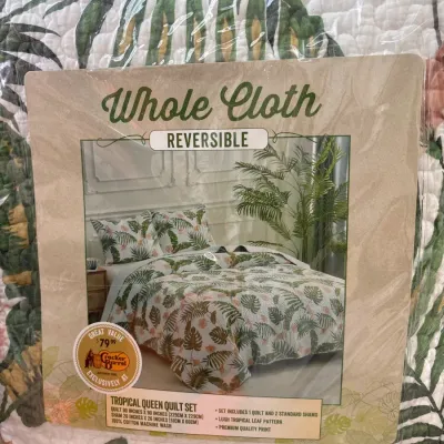 Whole Cloth brand reversible tropical queen quilt set in original plastic packaging, featuring a leaf and floral print.