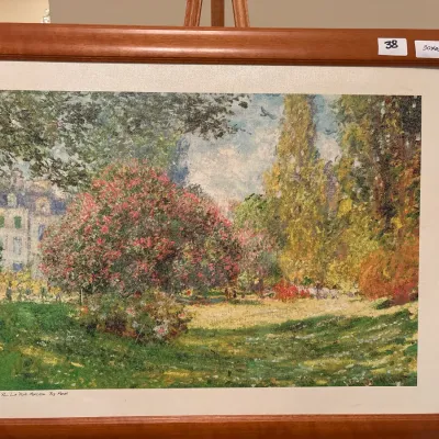 Framed print reproduction of Claude Monet's "Le Parc Monceau," housed in a simple reddish-brown wooden frame with a...