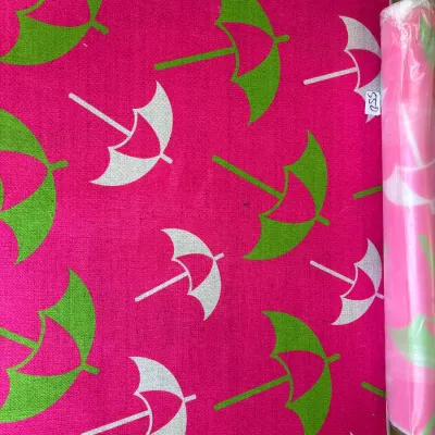 Vibrant hot pink area rug featuring a graphic green and white beach umbrella pattern, shown laid flat alongside a plastic-wrapped...