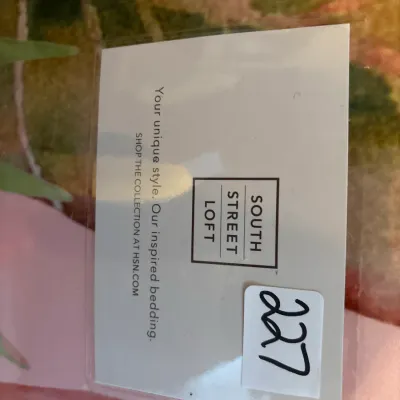 South Street Loft branded bedding insert tag in a plastic sleeve with a handwritten lot number sticker.