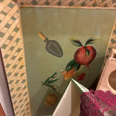 Hand-painted wooden serving tray featuring garden vegetables, a hand trowel, and a geometric lattice border.