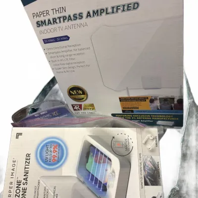 Boxed electronics accessories, including an Antop paper thin indoor TV antenna and a Sharper Image UV-Zone phone sanitizer.