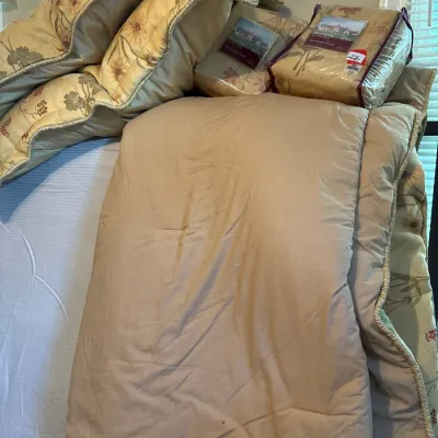 Biltmore brand floral bedding ensemble, including a comforter, pillow shams, and packaged drapery panels.
