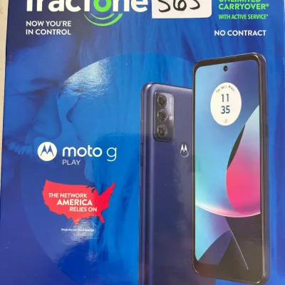 Tracfone Moto G Play smartphone in its original retail packaging, showing modern design and features.