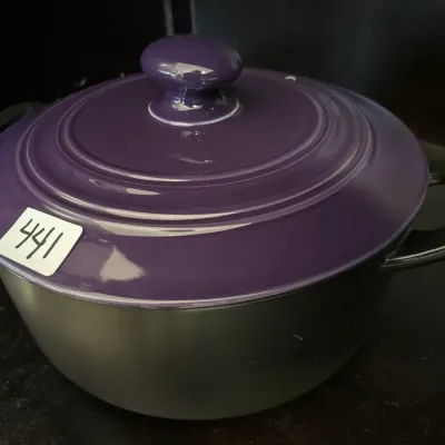 Le Creuset-style Dutch oven featuring a matte black base and a glossy purple lid with a round top knob.