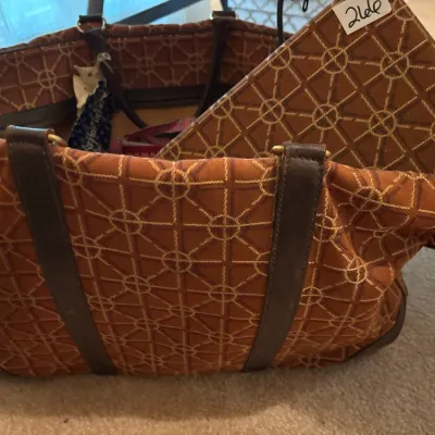 Vintage rust-orange patterned fabric luggage set featuring leather trim, brass hardware, and a matching accessory case.