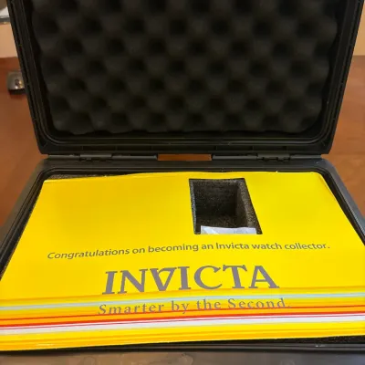 Open Invicta brand hard-shell collector's watch storage case with foam interior padding.