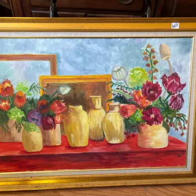 Framed still life oil painting on canvas depicting vibrant floral arrangements and yellow vases on a red table, housed in a molded...
