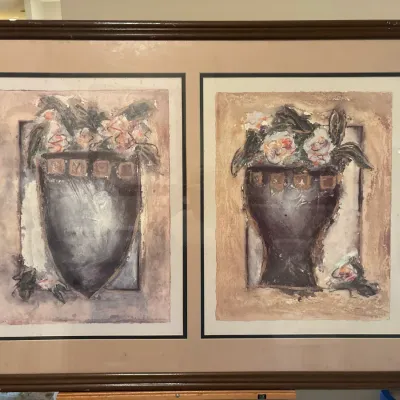 Framed dual-panel artwork featuring textured abstract floral still lifes in dark vases, presented in a dark wood frame with neutral...