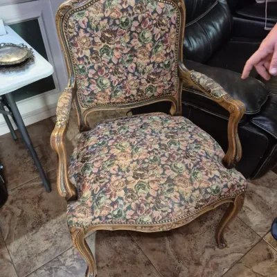 Sale Photo Thumbnail #7: Vintage French Provincial style armchair with carved wood frame, nailhead trim, and floral tapestry upholstery showing light wear.