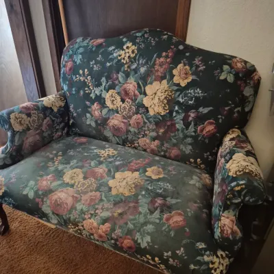 Sale Photo Thumbnail #23: Vintage upholstered loveseat featuring a dark green background with a dense pink and yellow floral pattern.