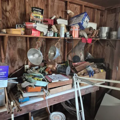 Sale Photo Thumbnail #105: Workshop workbench area lined with various tools, paint cans, clamp lamps, and hardware supplies.