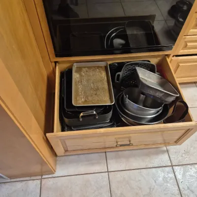 Sale Photo Thumbnail #51: Assorted baking sheets, pans, and cake tins organized in an open kitchen drawer.