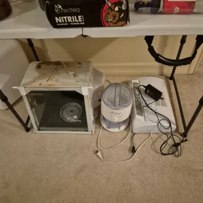 Sale Photo Thumbnail #70: Collection of small kitchen counter appliances and supplies, including a Ronco Showtime rotisserie oven, food chopper, vacuum sealer, and a box of Recteq black nitrile gloves.