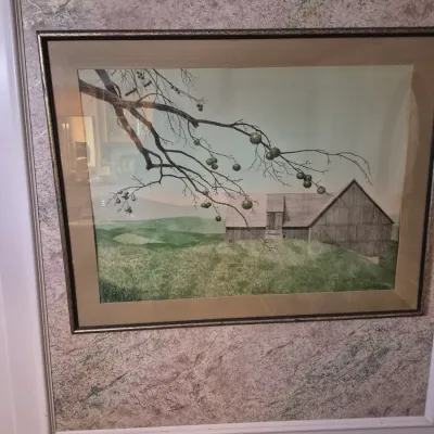 Sale Photo Thumbnail #72: Framed landscape art print featuring a rural scene with a wooden barn, rolling green hills, and an apple tree branch in the foreground.