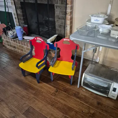 Sale Photo Thumbnail #5: Pair of personalized primary-colored wooden children's chairs shown beside kitchenware on a folding table and a toaster oven.
