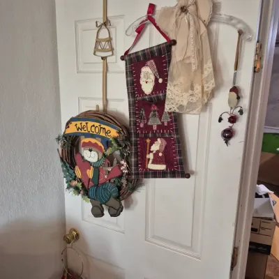 Sale Photo Thumbnail #45: Collection of rustic holiday door decor including a bear 'Welcome' wreath, fabric Santa wall hanging, and lace angel hanger.