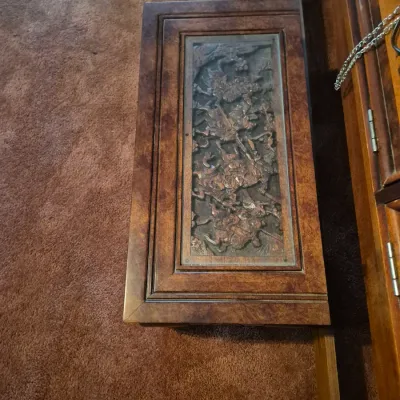 Sale Photo Thumbnail #39: Vintage Asian-style wooden chest featuring an intricately carved relief panel under glass depicting figures on horseback.
