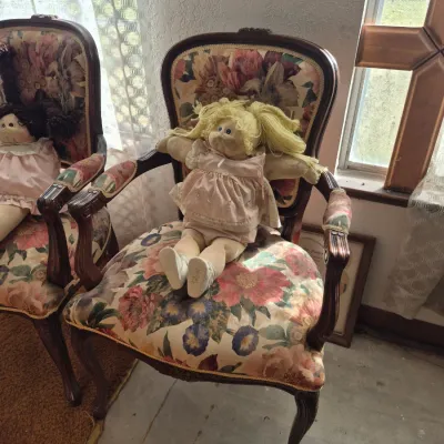 Sale Photo Thumbnail #14: Vintage Cabbage Patch Kids doll with blonde yarn hair resting on a French provincial style armchair upholstered in floral tapestry fabric.