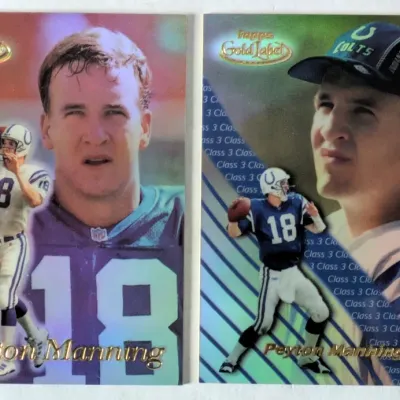 Pair of late 1990s Topps Gold Label Peyton Manning rookie-era football trading cards featuring holographic foil finishes.