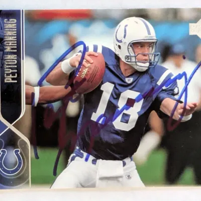 Autographed Upper Deck Peyton Manning Indianapolis Colts trading card featuring a blue marker signature across the front.
