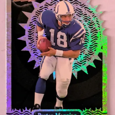 1998 Pacific Revolution Peyton Manning die-cut rookie trading card, featuring a holographic foil design.
