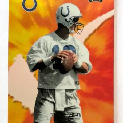 1998 Playoff football trading card featuring Peyton Manning in his Indianapolis Colts practice uniform against a fiery background graphic.