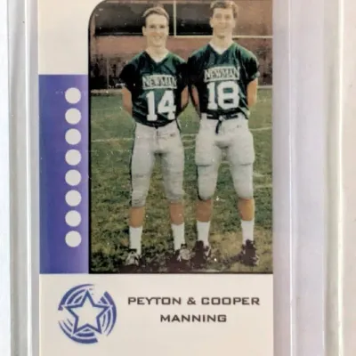 Peyton and Cooper Manning high school football trading card stored in a protective plastic top loader sleeve.