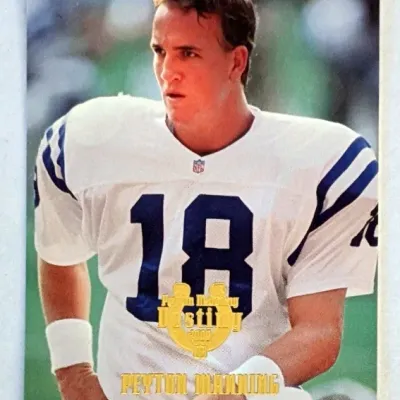 Peyton Manning Indianapolis Colts football trading card featuring gold foil lettering, highlighting a November 29, 1998 game against the...