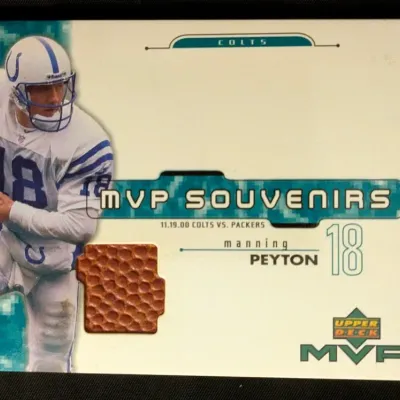 Upper Deck MVP Souvenirs Peyton Manning football relic trading card, featuring a piece of game-used football from the November 19, 2000...