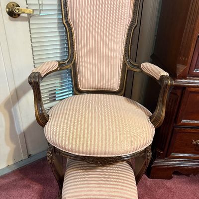 Vintage French Provincial style armchair with matching pull-out footrest, upholstered in pink and white striped fabric with carved dark...