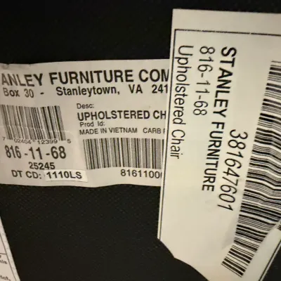 Sale Photo Thumbnail #168: Stanley Furniture Co. manufacturer labels on an upholstered chair, showing model number 816-11-68 and origin details.