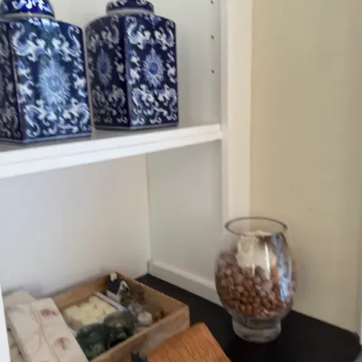 Sale Photo Thumbnail #148: Pair of blue and white chinoiserie tea caddy ginger jars displayed on a white shelf alongside decorative accessories.