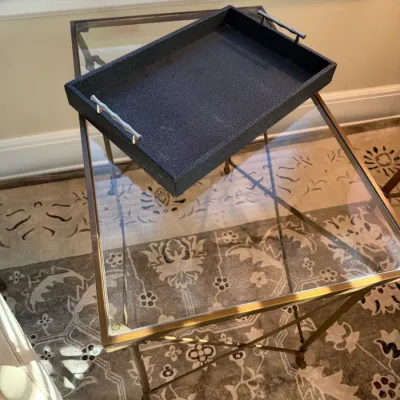 Sale Photo Thumbnail #167: Contemporary black faux-shagreen decorative tray with brushed metal handles, displayed atop a square brass and glass side table.